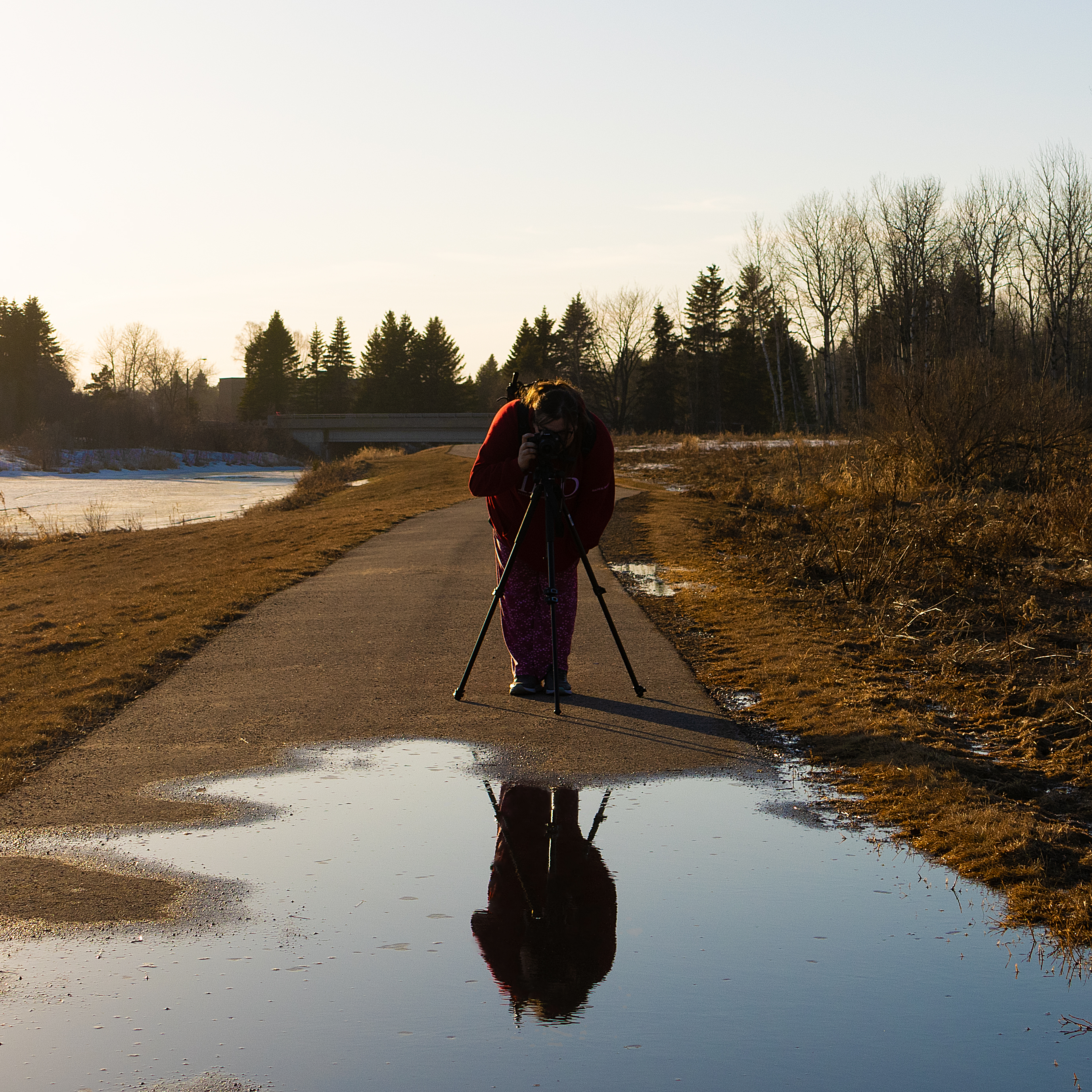 the reflection of a friend in a puddle